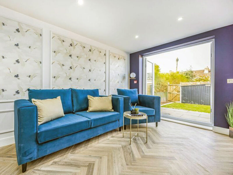 Finished living space with feature wall and bi-fold doors by SODA Building Services Ltd