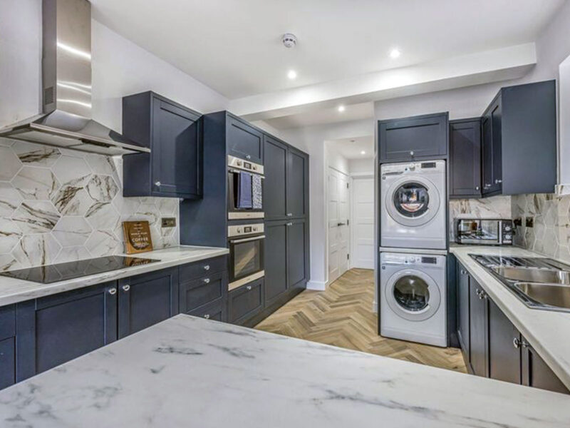 Modern kitchen refurbishment with fitted units and herringbone flooring by SODA Building Services Ltd