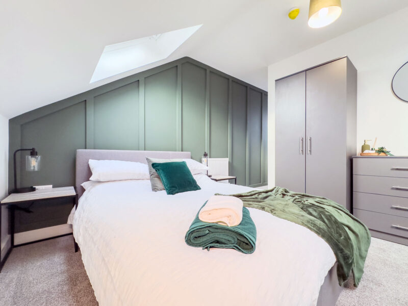 Finished bedroom refurbishment with feature wall and rooflight by SODA Building Services Ltd